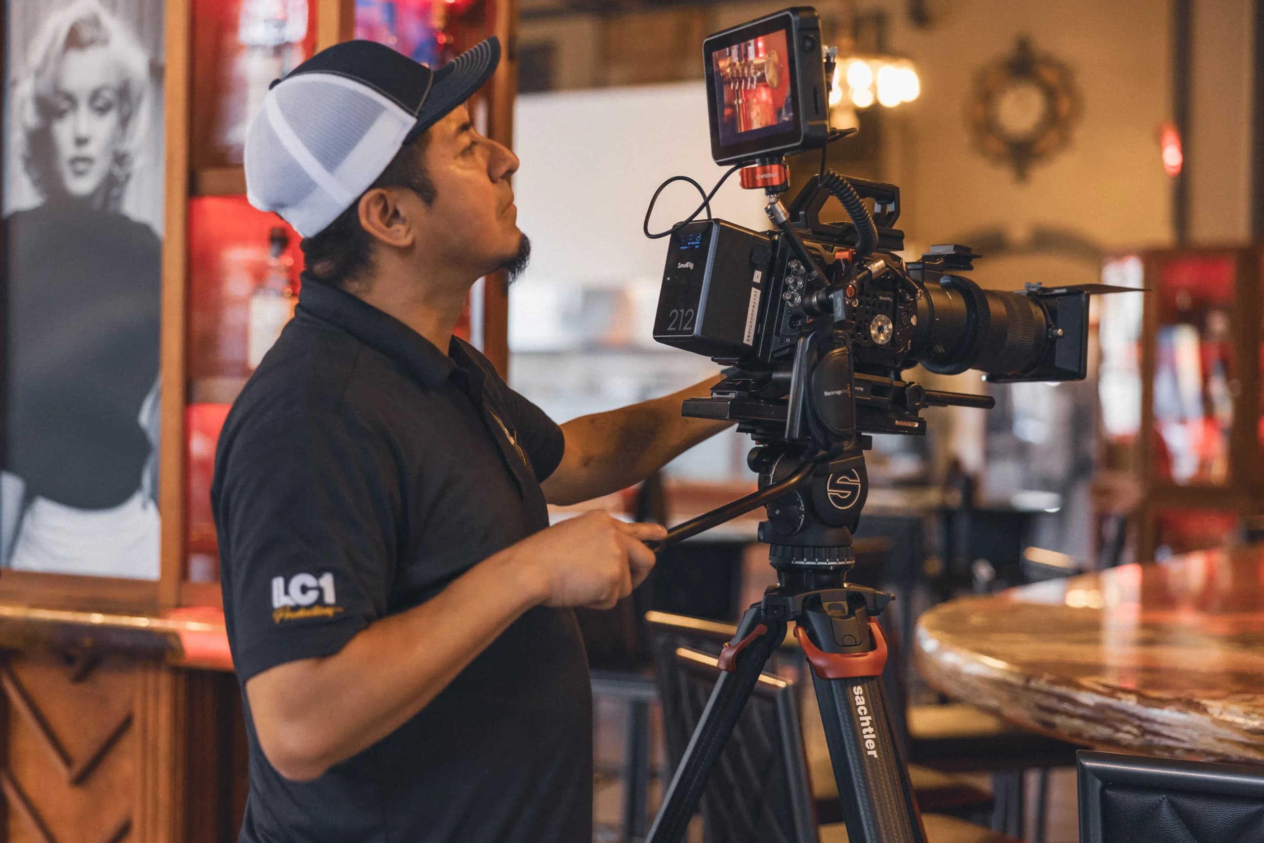 An LC1 Productions camera operator lining up a shot on location